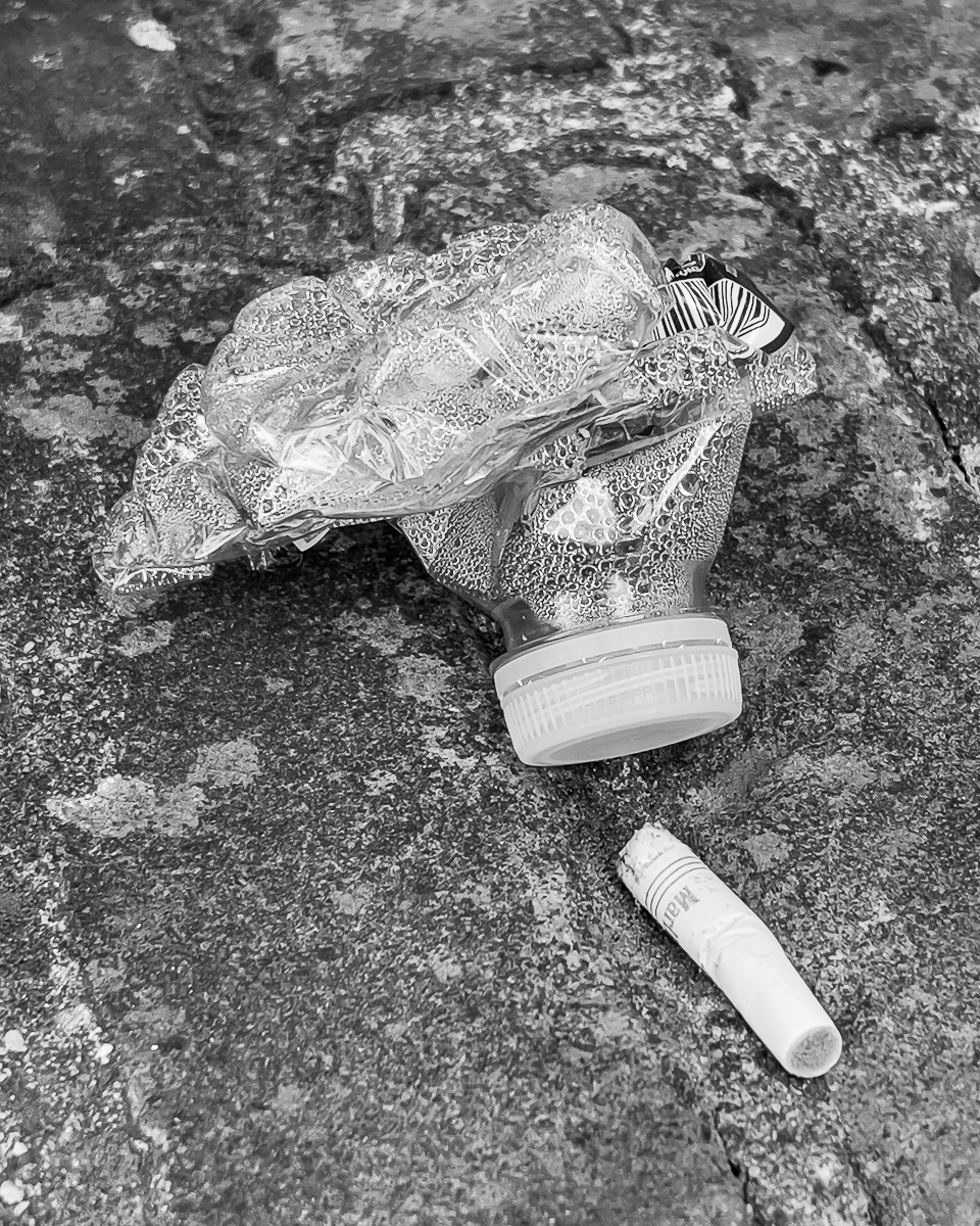 crumpled water bottle, Marlboro cigarette butt