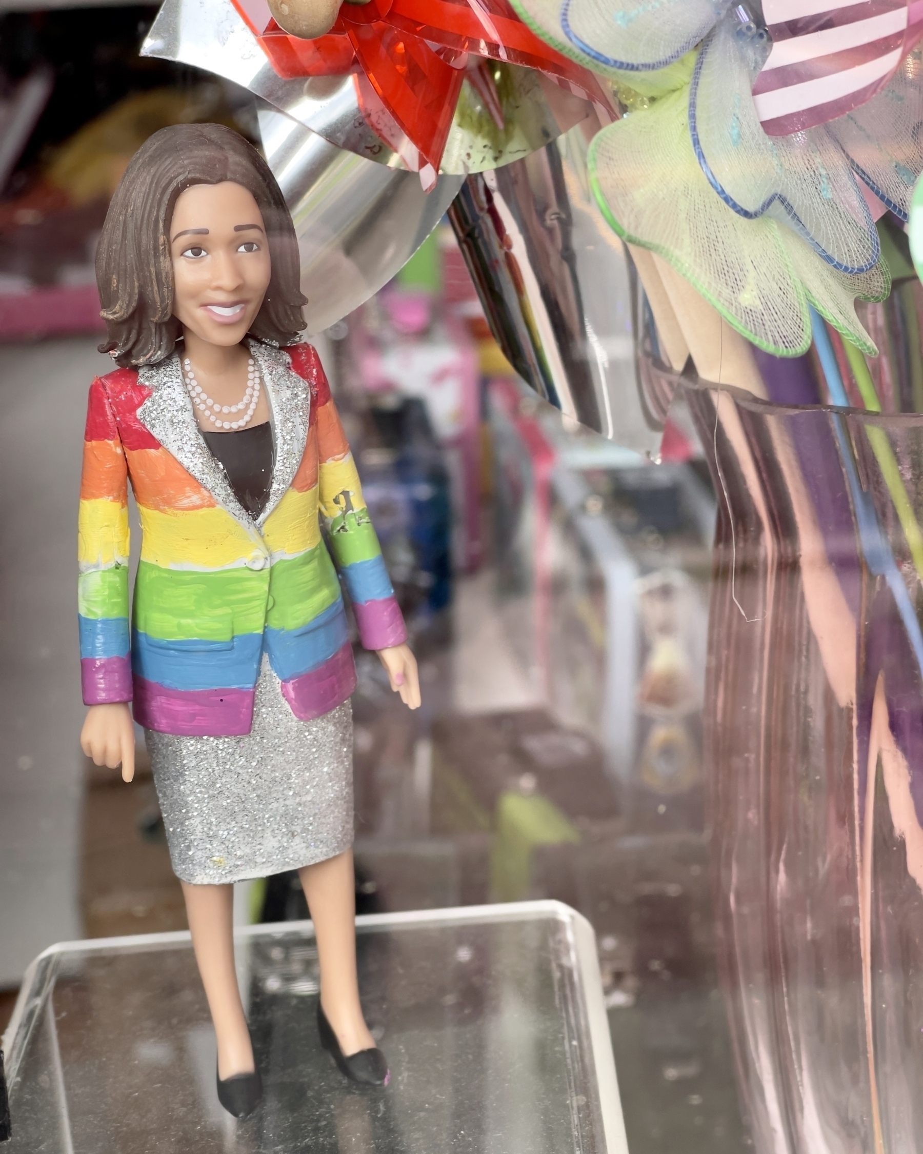Kamala Harris doll in gay pride jacket.